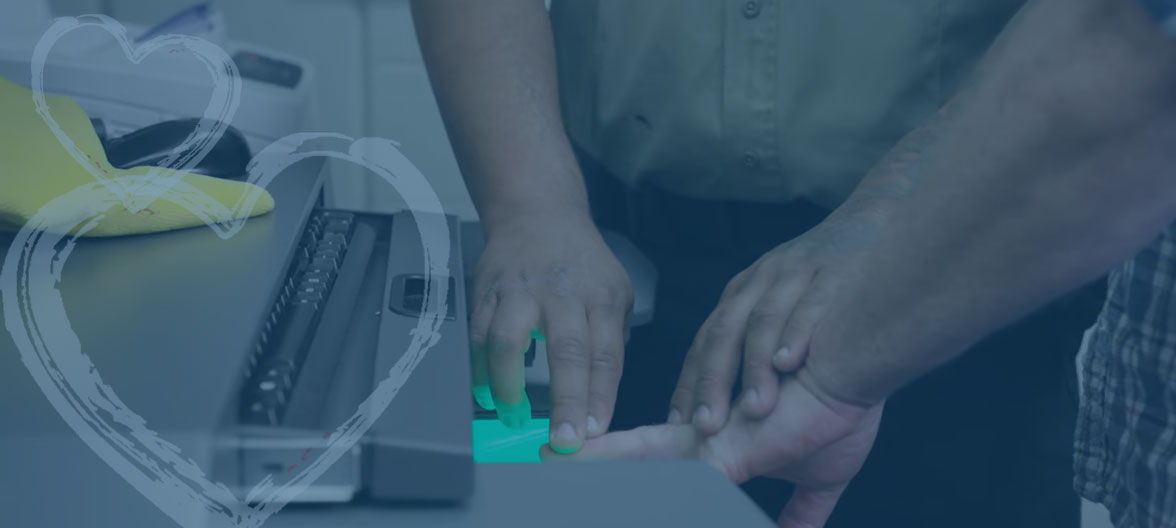 CS Officer taking fingerprints