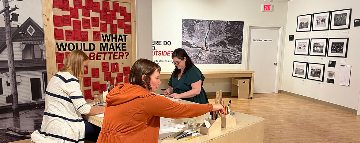 Three females at a desk drawing