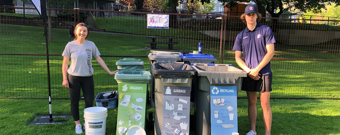 Female and male EcoSmart team member in front of a waste sorting station