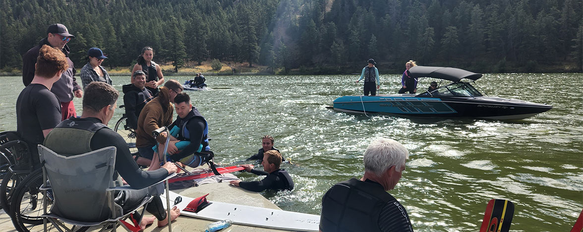 Spinal Cord Injury BC members on a dock along the river.