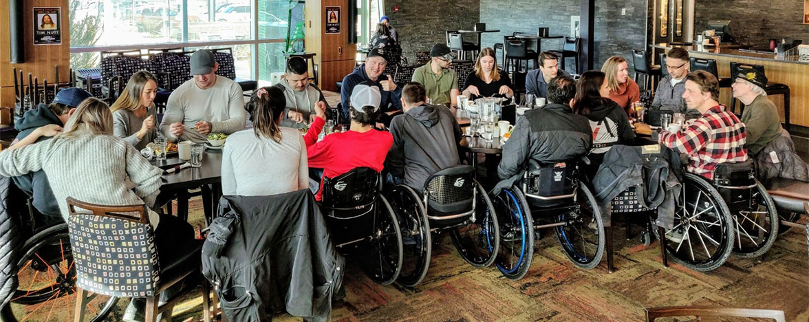 Spinal Cord Injury BC members at restaurant gathering.