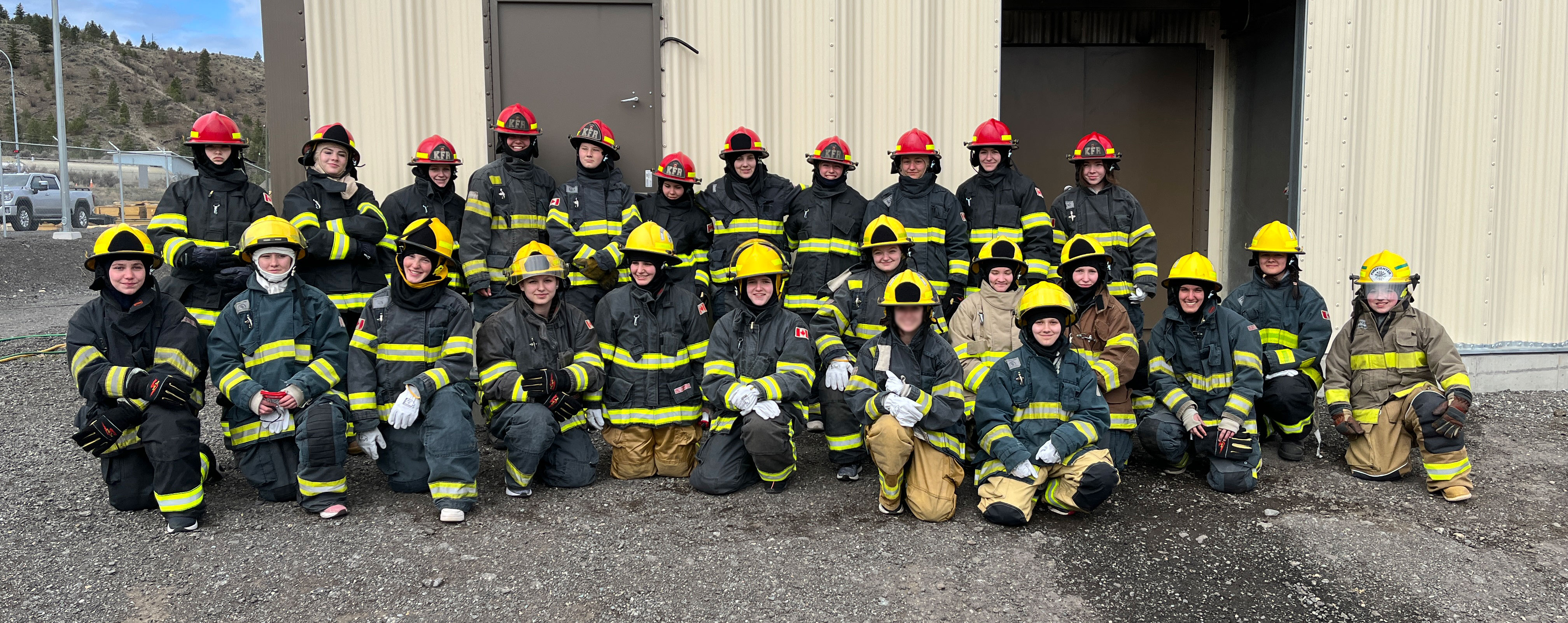 group shot of 30 students in firefighting gear