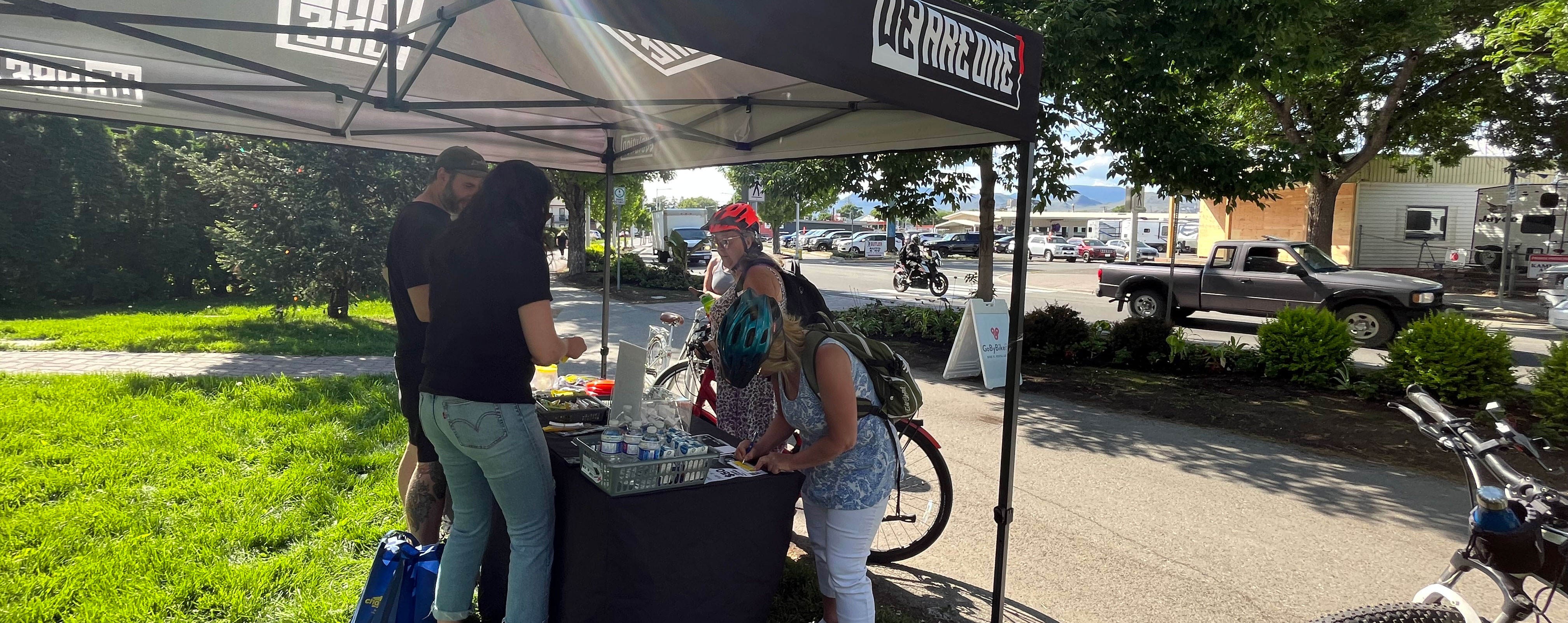 Bike riders underneath a black tent