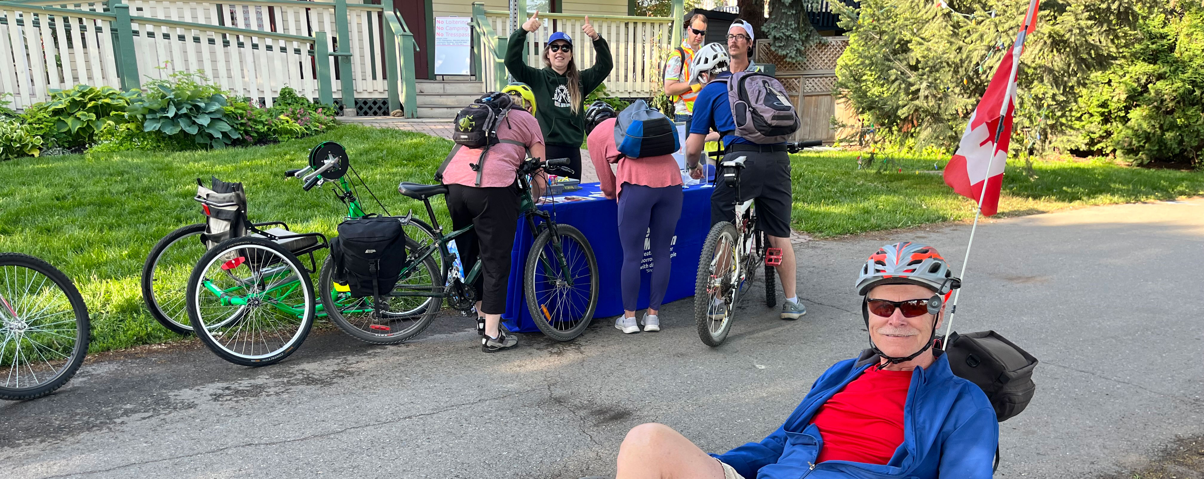 Various bike riders gathered on the sidewalk