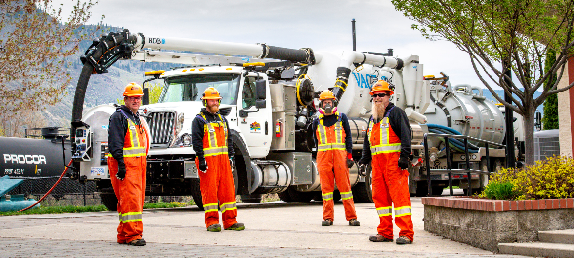 4 City workers standing in front of a City vehicle