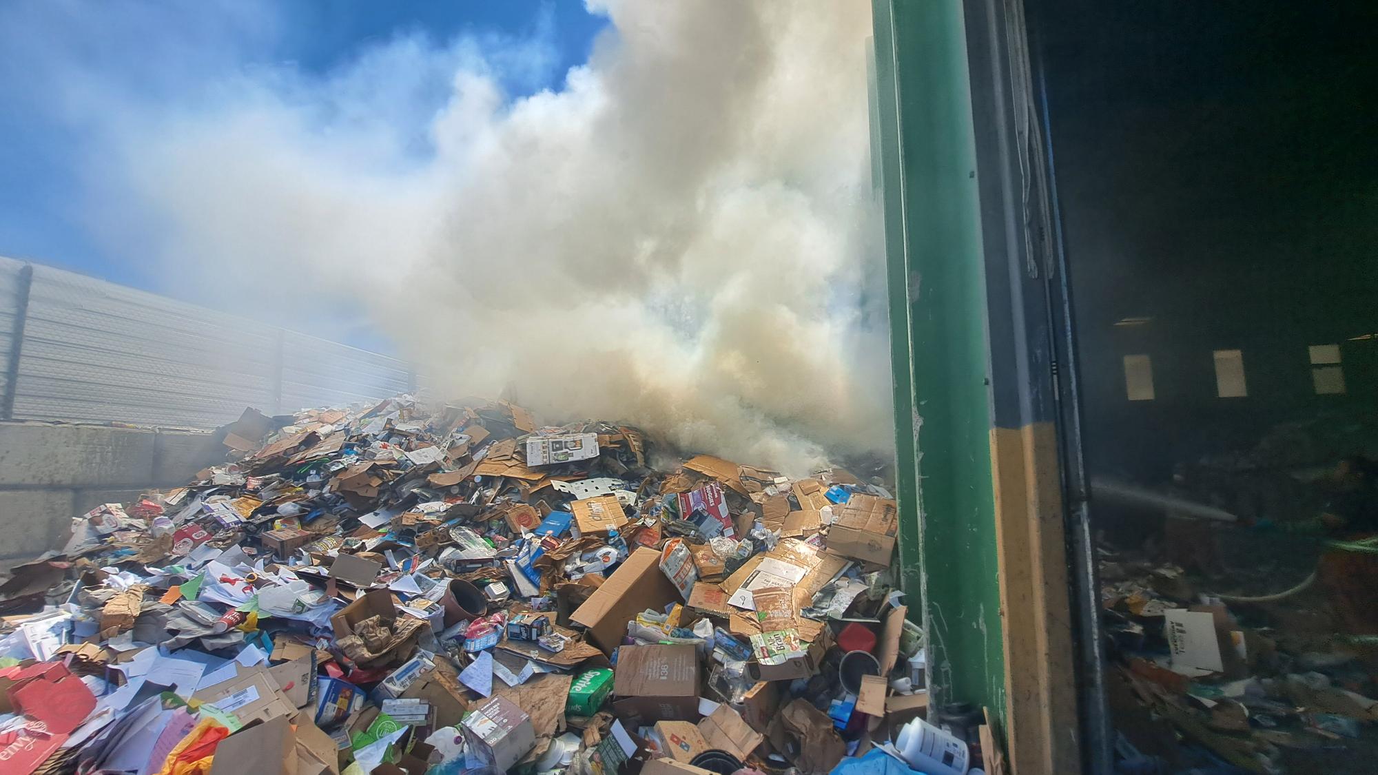 a pile of smouldering recyclable material at the Emterra Recycling Plant in Kamloops, BC, on June 19, 2025.