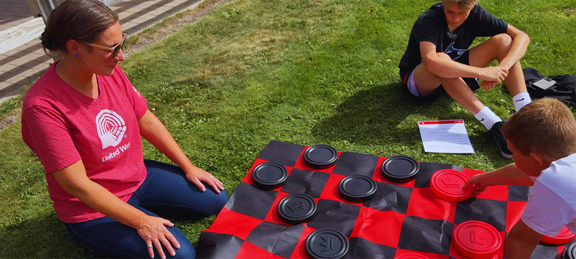 people playing giant checkers on the grass