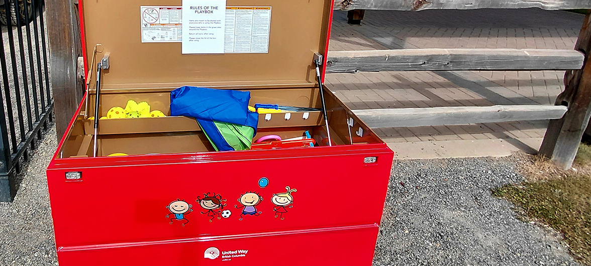 toys and games displayed inside a red metal playbox