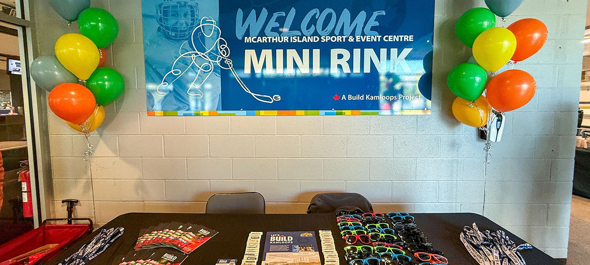 table with promotional materials and two sets of balloon columns