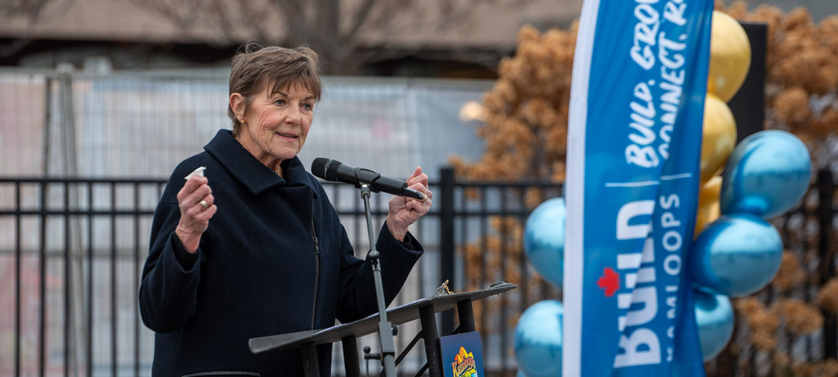 Women in black jacket speaking