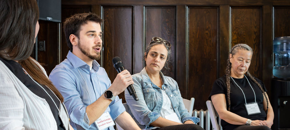 Four Heritage BC Conference participants seated alongside one another engaging in a panel discussion. 