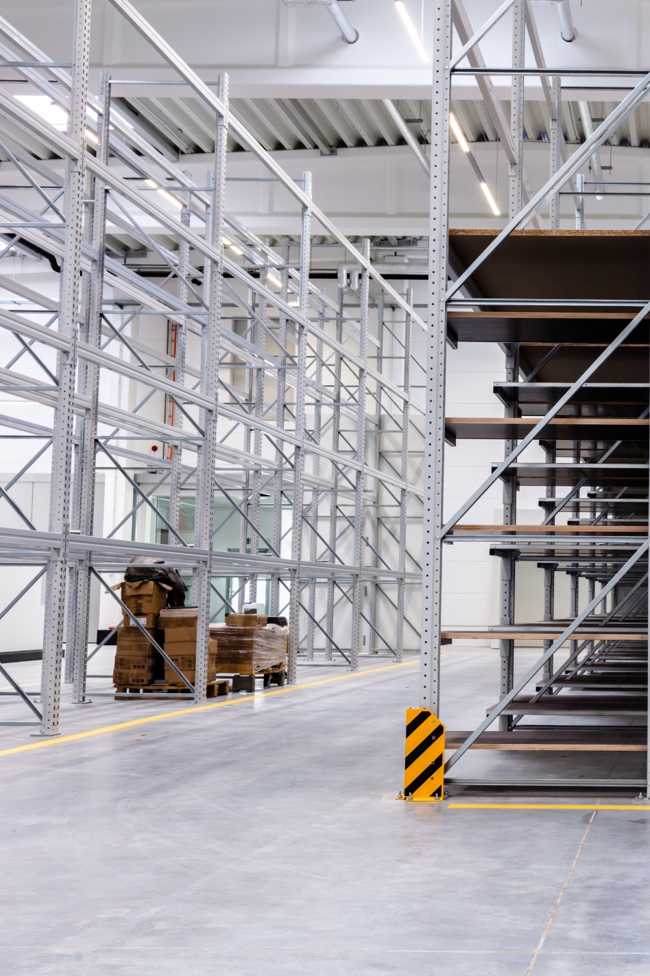 A commercial building warehouse room with floor to ceiling racking.