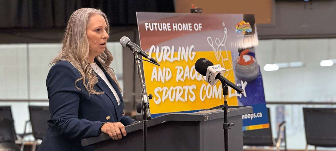 woman speaking at a microphone
