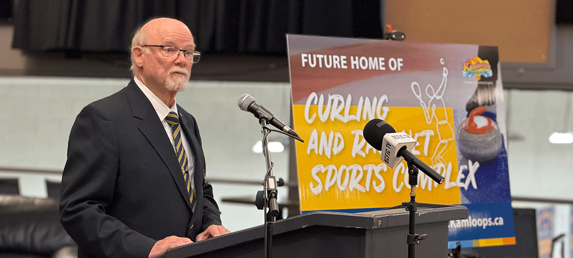 senior man speaking into a microphone