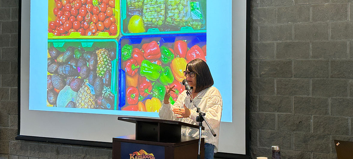 female speaker in front of powerpoint presentation