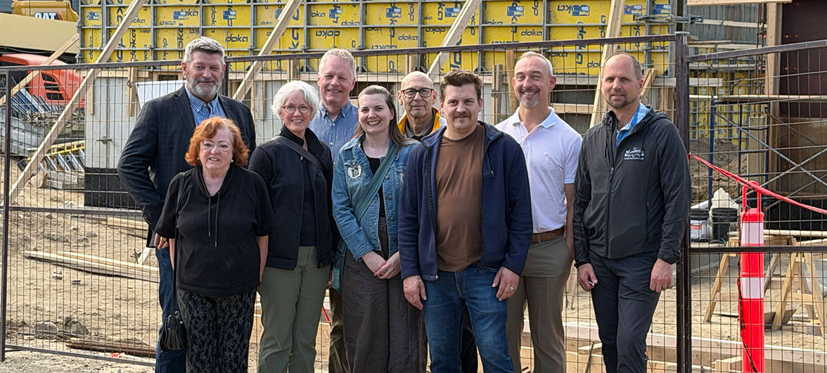 Group photo in front of construction site