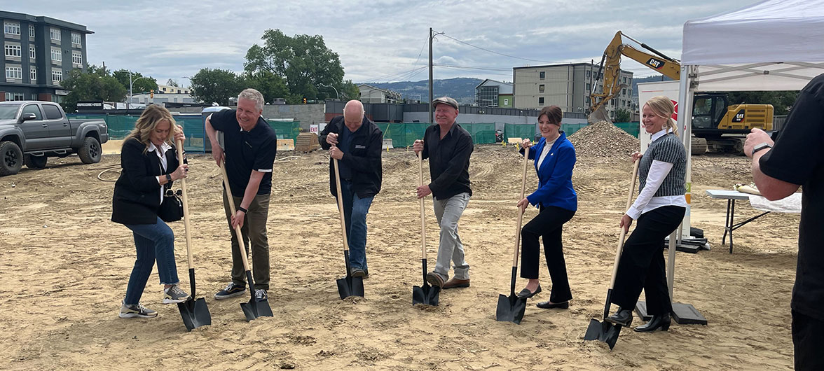 Six individuals holding shovels