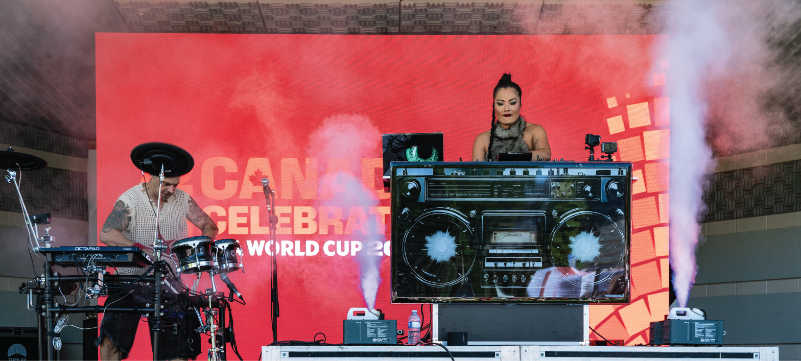 a DJ on stage at the Riverside Park Rotary Bandshell 