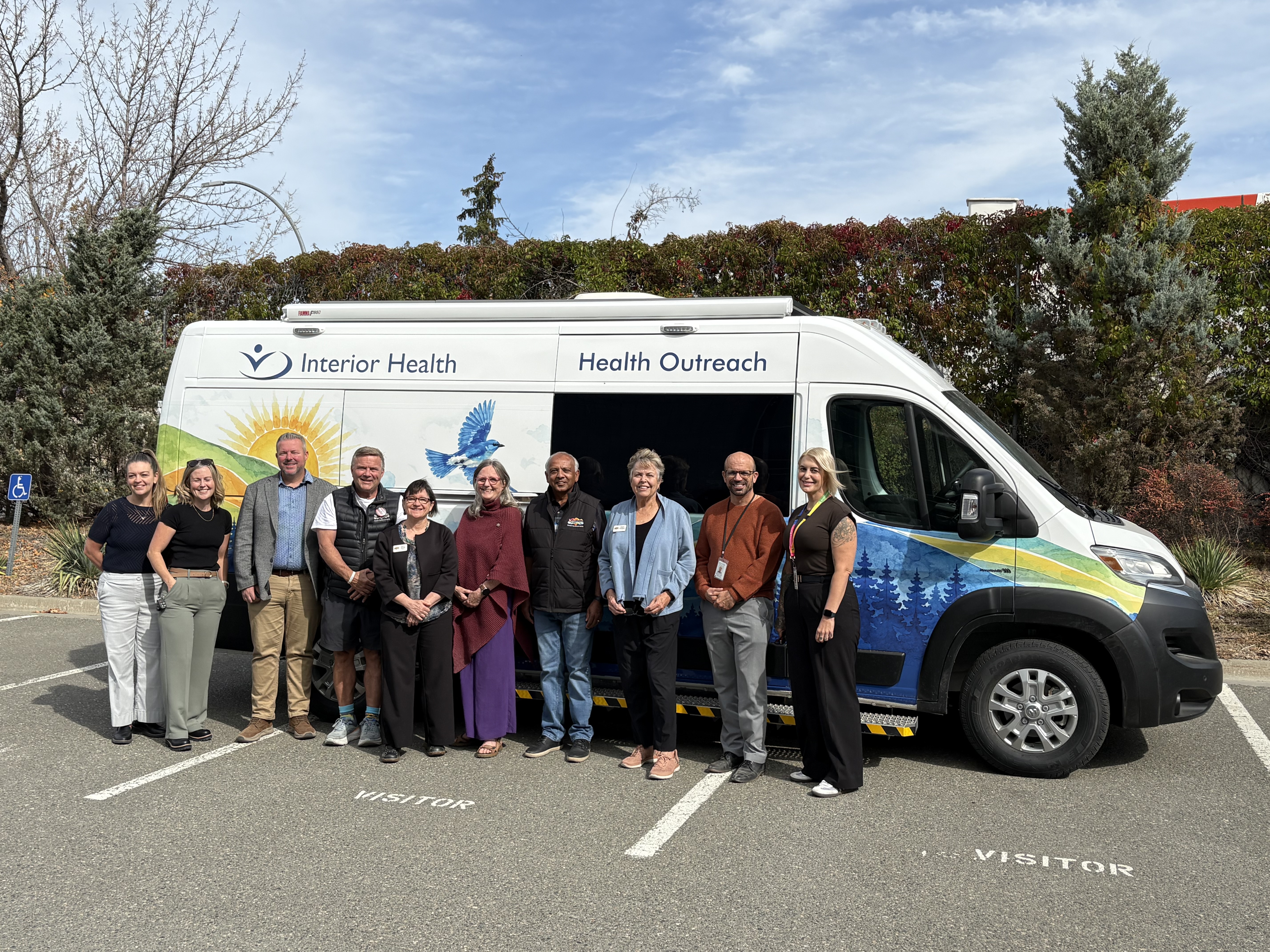 Group photo in front of a white van