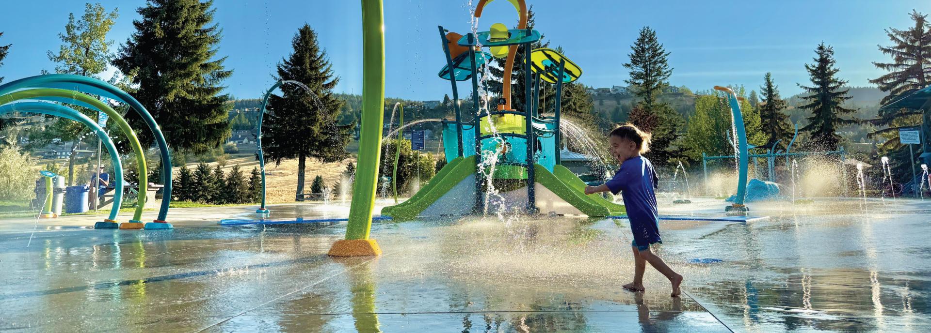 A kid playing in a water park