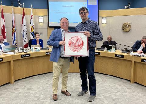 Mayor and the artist holding the artwork about Red Bridge
