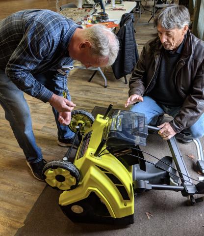 2 men repairing a machine