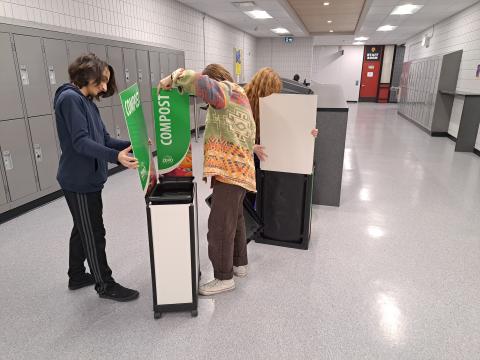 Some people setting up compost bins