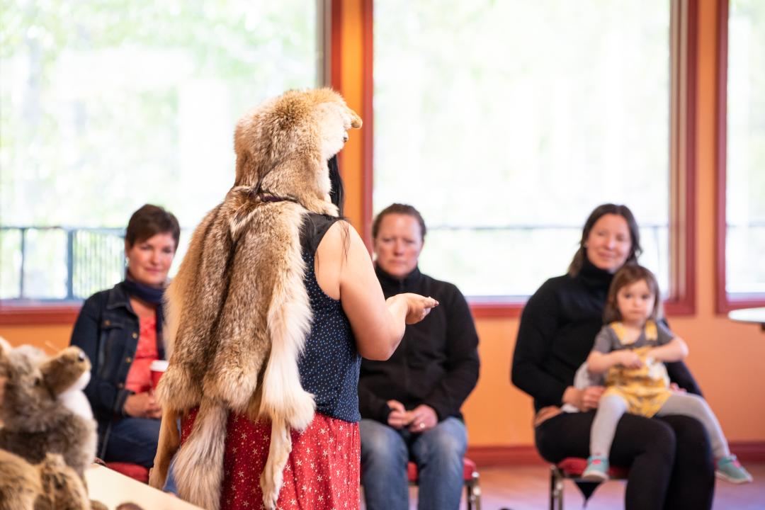Indigeous story teller wearing a coyote fur
