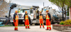 4 City workers standing in front of a City vehicle